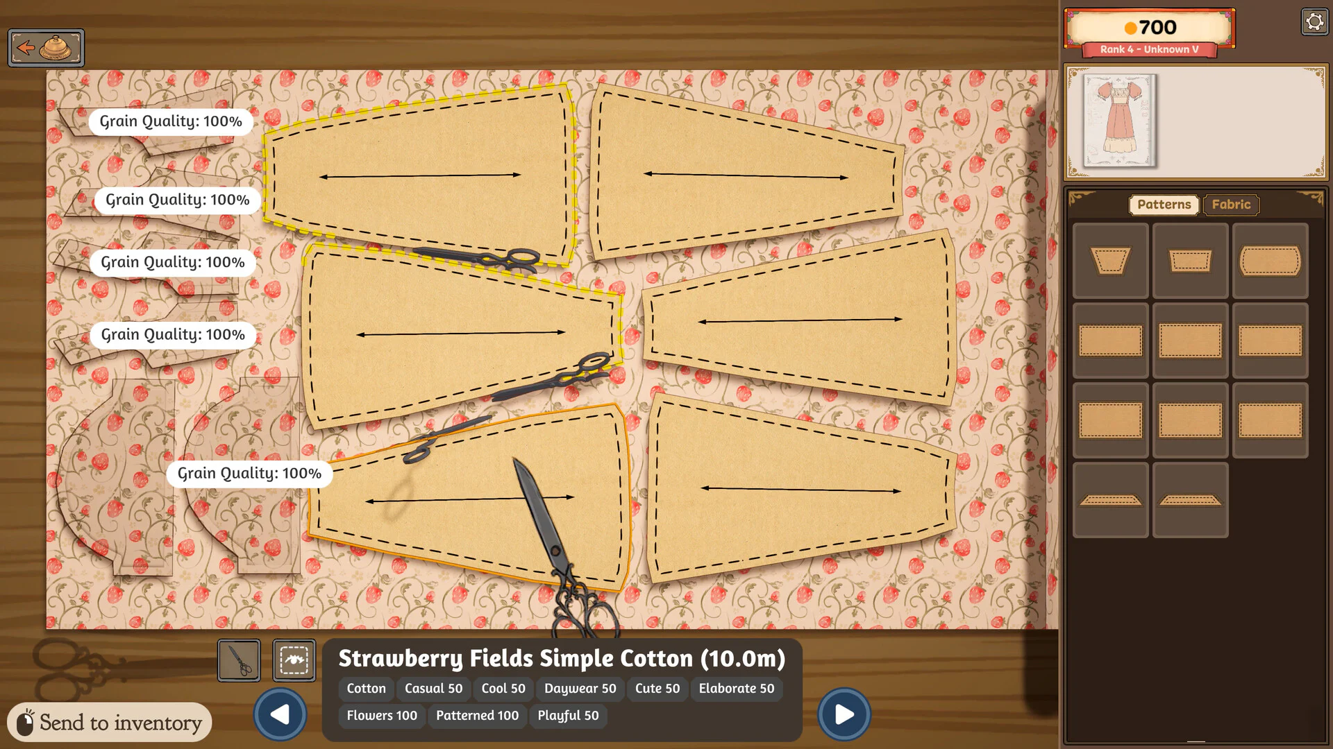 Dress pattern pieces arranged on strawberry-print cotton with 100 percent grain quality indicators