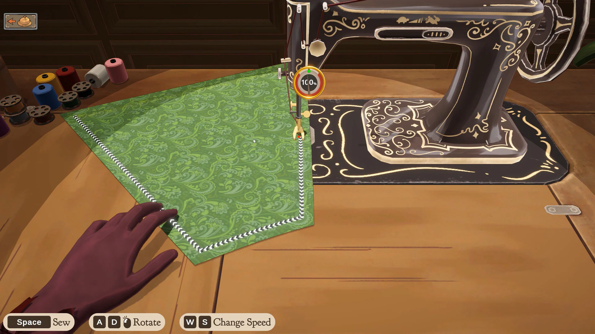 First-person sewing-machine view in Dressmaker stitching a green patterned fabric panel
